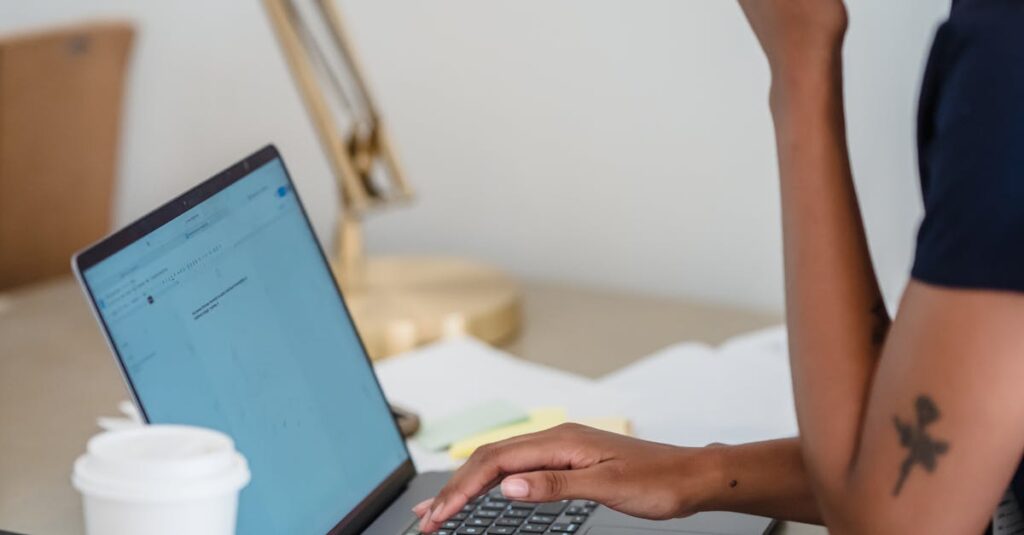 pexels-photo-12911258-12911258 Young woman concentrates while working on a laptop at a stylish desk setup.