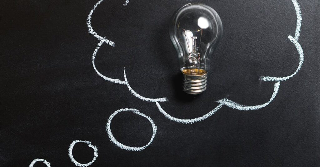 pexels-photo-355952-355952 Light bulb laying on chalkboard with drawn thought bubble, symbolizing creative ideas.