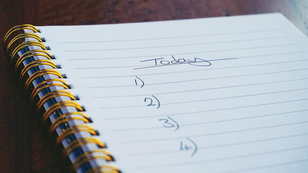 pexels-photo-1226398-1226398 A close-up view of a handwritten to-do list on a spiral notebook with numbers for tasks.